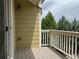Private outdoor deck with views of foliage and wooden railing and siding on home at 11947 Riverstone Cir # 7F, Henderson, CO 80640