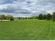 Beautifully maintained community green space with lush grass and mature trees at 11947 Riverstone Cir # 7F, Henderson, CO 80640