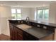 Bright kitchen view features a countertop with sink, and multiple large windows for natural light at 11947 Riverstone Cir # 7F, Henderson, CO 80640