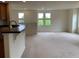 Open living space with scenic views from the multiple windows providing natural light, complemented by neutral walls at 11947 Riverstone Cir # 7F, Henderson, CO 80640