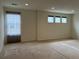 Bright, open room with neutral carpet and multiple windows for natural light at 11947 Riverstone Cir # 7F, Henderson, CO 80640