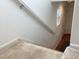 Carpeted stairs featuring a white handrail, providing safe access to the upper level of the home at 11947 Riverstone Cir # 7F, Henderson, CO 80640