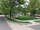 Street view of the corner of Riverton and Oak Hill in the community with sidewalks and mature trees at 11947 Riverstone Cir # 7F, Henderson, CO 80640