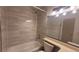 Modern bathroom featuring a shower over tub and a large mirror at 1818 S Quebec Way # 5-7, Denver, CO 80231