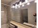 Nicely renovated bathroom with modern fixtures, vanity lights, and tiled shower at 1818 S Quebec Way # 5-7, Denver, CO 80231