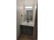 Bathroom vanity with sink, marble countertop, and grey cabinets, illuminated by modern lighting at 1818 S Quebec Way # 5-7, Denver, CO 80231