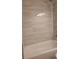 Bathroom featuring tiled walls, shower head, and a clean, bright appearance at 1818 S Quebec Way # 5-7, Denver, CO 80231
