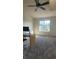 Spacious bedroom featuring a large window, ceiling fan, and neutral-toned carpet at 1818 S Quebec Way # 5-7, Denver, CO 80231