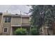Neutral colored townhouse exterior highlighting building number and mature trees at 1818 S Quebec Way # 5-7, Denver, CO 80231