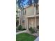 Townhouse exterior featuring manicured lawn and garden beds at 1818 S Quebec Way # 5-7, Denver, CO 80231