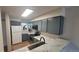 Modern kitchen with stainless steel appliances, gray cabinets, and marble countertops at 1818 S Quebec Way # 5-7, Denver, CO 80231