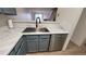 Stylish kitchen features a stainless steel sink with a gooseneck faucet and white countertops at 1818 S Quebec Way # 5-7, Denver, CO 80231