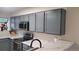 Well-lit kitchen features grey cabinets, stainless steel appliances, and light countertops at 1818 S Quebec Way # 5-7, Denver, CO 80231