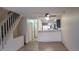 Spacious living room with hardwood floors, access to the kitchen, and stairs to the bedrooms at 1818 S Quebec Way # 5-7, Denver, CO 80231