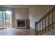 Living room with fireplace, access to balcony, and staircase at 1818 S Quebec Way # 5-7, Denver, CO 80231