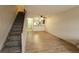 Open-concept living area, showcasing a staircase and a kitchen with stylish countertop seating at 1818 S Quebec Way # 5-7, Denver, CO 80231