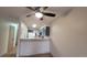 Open-concept living area showcasing the kitchen with grey cabinets and stylish countertop seating at 1818 S Quebec Way # 5-7, Denver, CO 80231