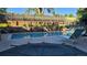 Community pool with lounge chairs and mature trees providing shade and a scenic backdrop at 1818 S Quebec Way # 5-7, Denver, CO 80231