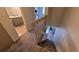 Carpeted staircase leading to the living room with fireplace and bathroom at 1818 S Quebec Way # 5-7, Denver, CO 80231