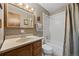 Cozy bathroom with a shower-tub combo, classic vanity, and mirrored medicine cabinet at 6651 S Dudley Ct, Littleton, CO 80123