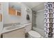 Bathroom showcasing a shower-tub combination, neutral walls, and modern vanity at 6651 S Dudley Ct, Littleton, CO 80123