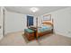 Bedroom boasting a four-poster bed with wood accents, storage chest and neutral carpeting at 6651 S Dudley Ct, Littleton, CO 80123