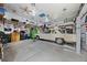 Inside of the garage with three car bays, lift, car and plenty of storage space at 6651 S Dudley Ct, Littleton, CO 80123