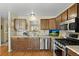 Updated kitchen featuring stainless steel appliances, sleek countertops, and natural light at 6651 S Dudley Ct, Littleton, CO 80123