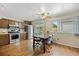Well-lit kitchen and dining area with stainless steel appliances and wood flooring at 6651 S Dudley Ct, Littleton, CO 80123