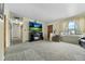 Inviting living room with neutral walls, gray carpet, and a cozy fireplace at 6651 S Dudley Ct, Littleton, CO 80123