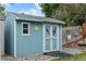Backyard shed with double doors and charming eagle silhouette design at 6651 S Dudley Ct, Littleton, CO 80123
