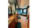 Spacious bathroom featuring custom vanity, copper sink, and soaking tub with mountain views at 4618 Se Summit Trl, Evergreen, CO 80439