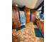 Well-lit bathroom featuring wood cabinets, neutral walls, patterned floor tiles, and a shower with attractive curtain at 4618 Se Summit Trl, Evergreen, CO 80439