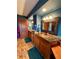 Bathroom with wood cabinets, beautiful brown tile floor, copper sinks and blue walls at 4618 Se Summit Trl, Evergreen, CO 80439
