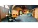 Expansive primary suite boasting plush carpet, lounge area, and private balcony access at 4618 Se Summit Trl, Evergreen, CO 80439