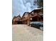Exterior showing multiple structures, a driveway, and a basketball hoop at 4618 Se Summit Trl, Evergreen, CO 80439