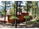 Exterior view of a beautiful, wood-clad home nestled in a wooded setting at 4618 Se Summit Trl, Evergreen, CO 80439