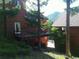 Wood-sided home exterior showcasing an elevated deck with a connecting walkway through the trees to the second building at 4618 Se Summit Trl, Evergreen, CO 80439
