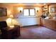 Comfortable home office features built-in shelves, cabinets, and a large window for natural light at 4618 Se Summit Trl, Evergreen, CO 80439