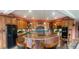 Gourmet kitchen with custom cabinets, granite countertops, and a breakfast bar at 4618 Se Summit Trl, Evergreen, CO 80439