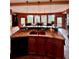 Open kitchen with granite counters, double sinks, and dining area with mountain views at 4618 Se Summit Trl, Evergreen, CO 80439
