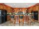 Spacious kitchen with a large island, seating, granite countertop, wooden cabinets and modern appliances at 4618 Se Summit Trl, Evergreen, CO 80439