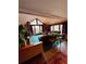 Cozy living room with a vaulted ceiling, wood-burning stove, and large windows overlooking the forest at 4618 Se Summit Trl, Evergreen, CO 80439