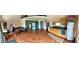 Open-concept living room with wood floors and a kitchenette area at 4618 Se Summit Trl, Evergreen, CO 80439