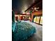 Spacious main bedroom with blue ceiling, lounge area and balcony access at 4618 Se Summit Trl, Evergreen, CO 80439