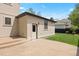 Backyard with a concrete patio, a lawn, and a detached garage with a white door at 2500 S Monroe St, Denver, CO 80210