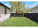 Backyard with lush green grass and a fenced-in yard at 2500 S Monroe St, Denver, CO 80210