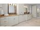 Bright bathroom showcasing double vanities with granite countertops and ample storage space at 2500 S Monroe St, Denver, CO 80210