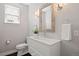 Stylish powder room featuring a modern vanity, decorative mirror, and elegant lighting fixtures at 2500 S Monroe St, Denver, CO 80210