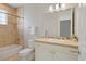 Bathroom features a vanity, a large mirror, and a tiled shower-over-tub combo at 2500 S Monroe St, Denver, CO 80210